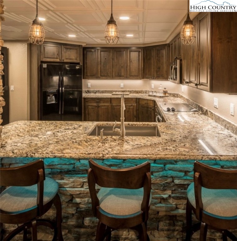 356 Upper Reach Drive Vilas, NC 28692 - Photo 27 of 49 a kitchen with kitchen island granite countertop a table and chairs in it