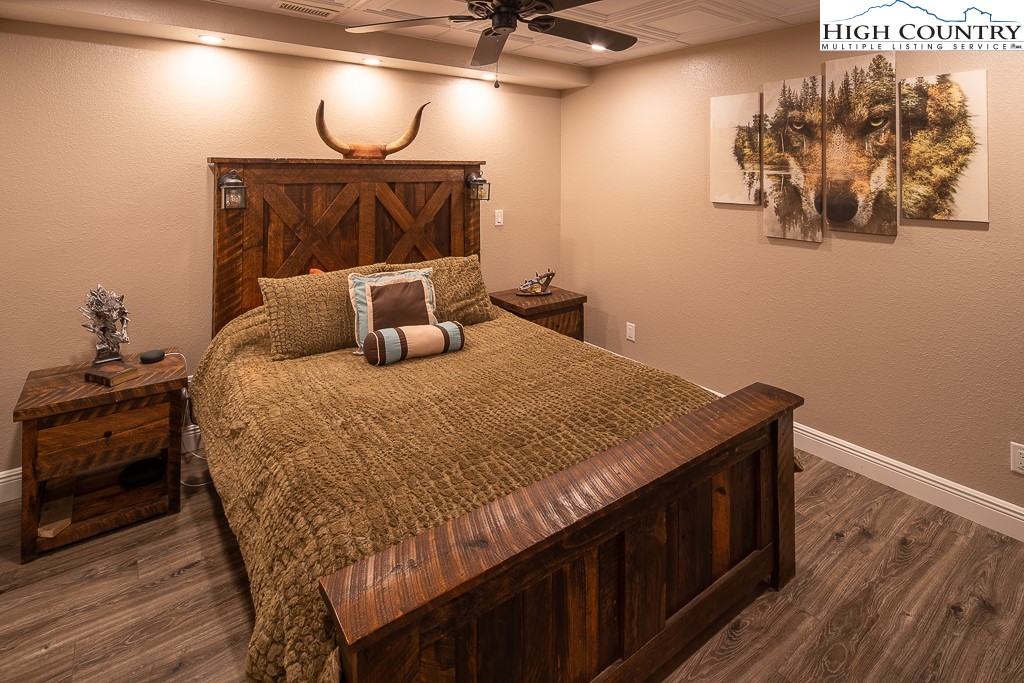 356 Upper Reach Drive Vilas, NC 28692 - Photo 31 of 49 a bedroom with a bed and wooden floor