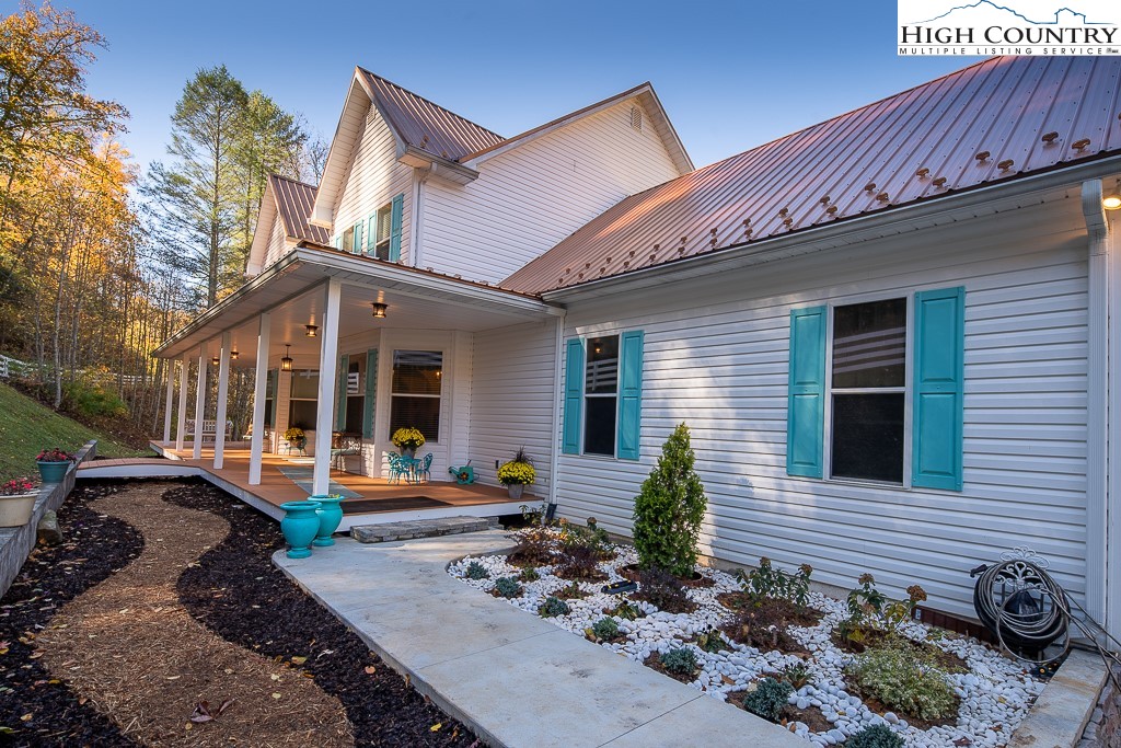356 Upper Reach Drive Vilas, NC 28692 - Photo 33 of 49 a front view of a house with garden