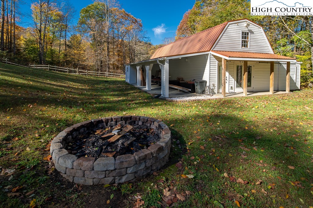 356 Upper Reach Drive Vilas, NC 28692 - Photo 38 of 49 a view of a house with roof deck with couches and wooden fence