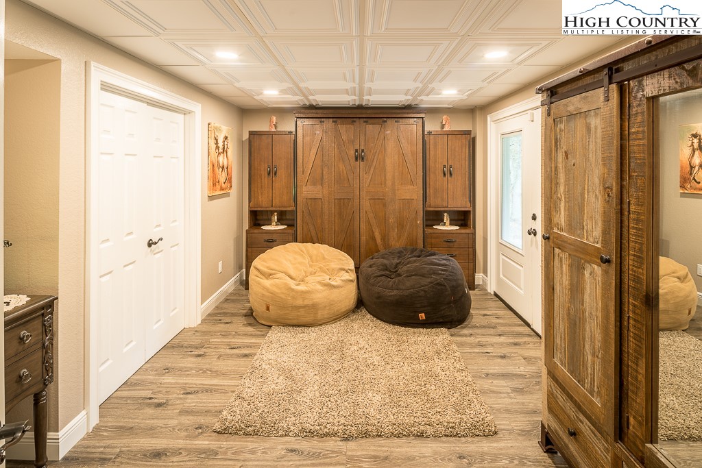 356 Upper Reach Drive Vilas, NC 28692 - Photo 41 of 49 a bedroom with a bed and a chandelier