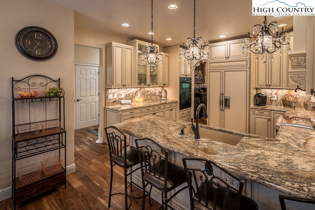 356 Upper Reach Drive Vilas, NC 28692 - Photo 10 of 49 a kitchen with stainless steel appliances granite countertop a kitchen island a stove and a wooden floors