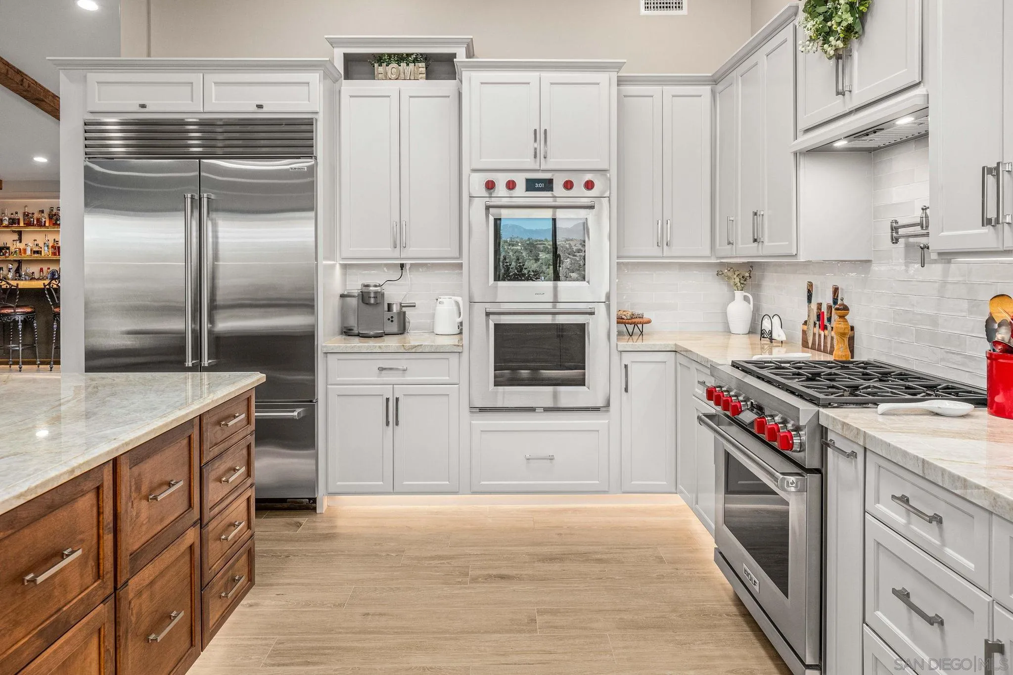a kitchen with stainless steel appliances granite countertop a stove a refrigerator and a sink