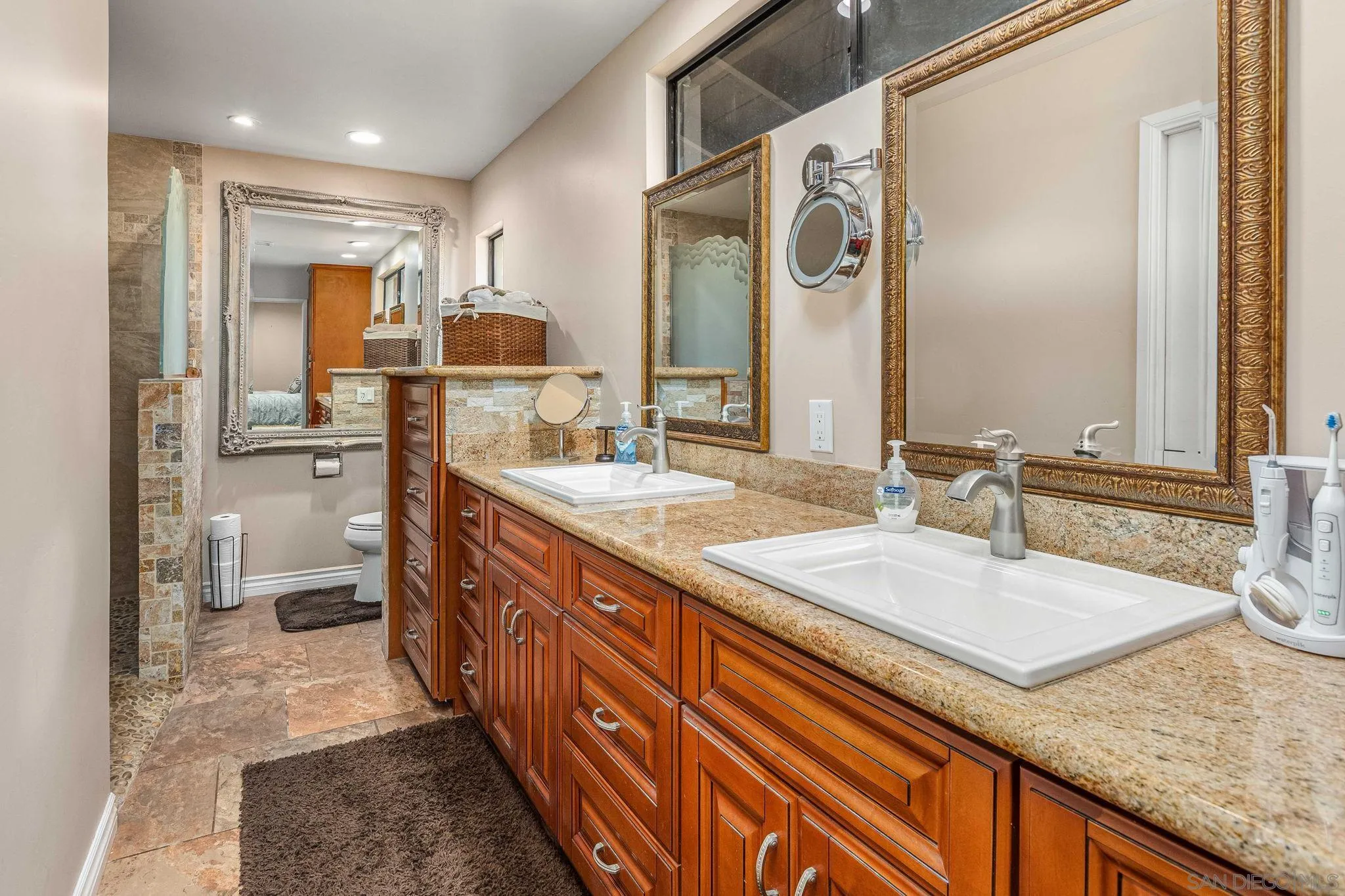 2302 Casitas Del Sol Fallbrook, CA 92028 - Photo 19 of 46 a spacious bathroom with a granite countertop sink and a mirror