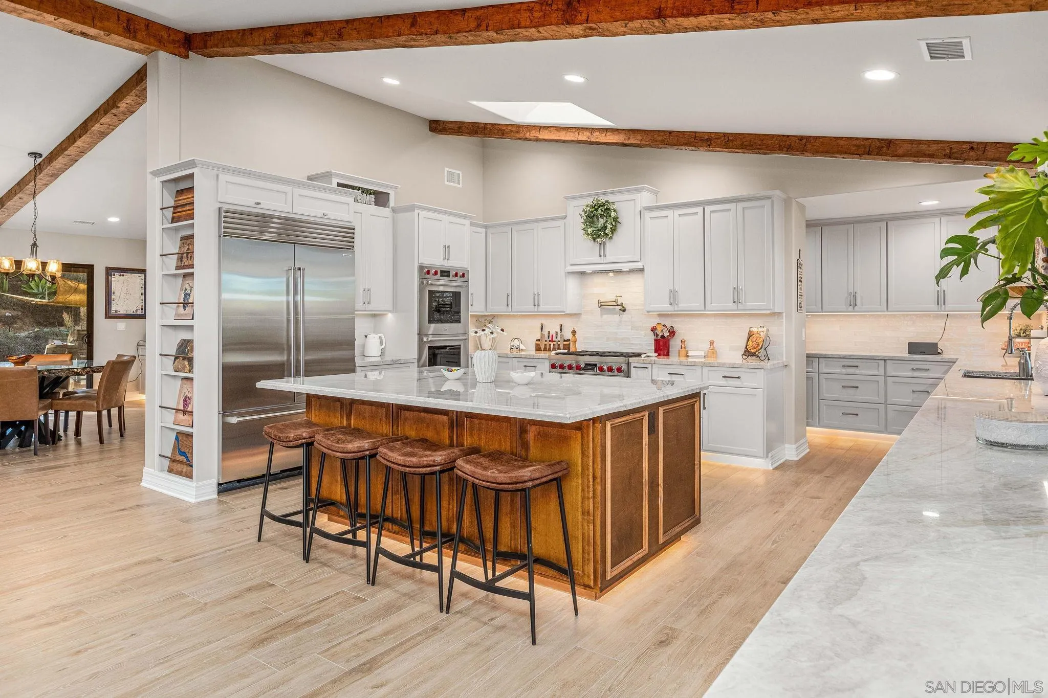 2302 Casitas Del Sol Fallbrook, CA 92028 - Photo 4 of 46 a kitchen with stainless steel appliances granite countertop a table chairs sink and cabinets