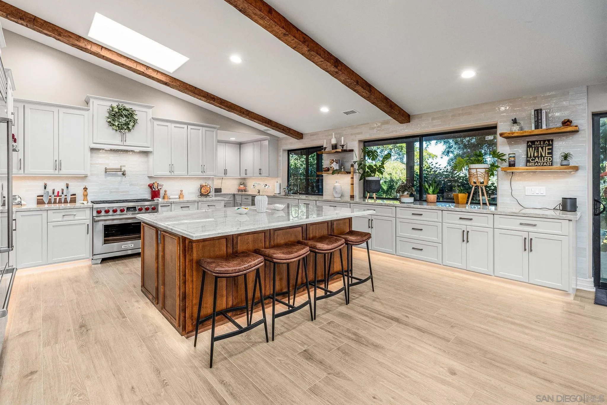 2302 Casitas Del Sol Fallbrook, CA 92028 - Photo 6 of 46 a kitchen with stainless steel appliances kitchen island granite countertop a sink cabinets and wooden floor
