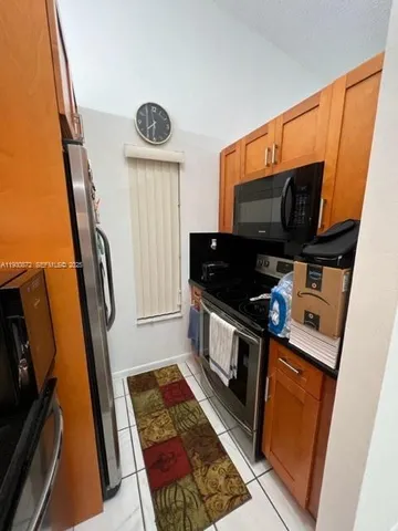 a kitchen with granite countertop a sink and a stove top oven
