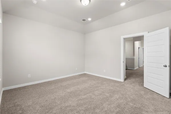 an empty room with closet and natural light