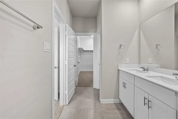a bathroom with a granite countertop sink mirror and a shower