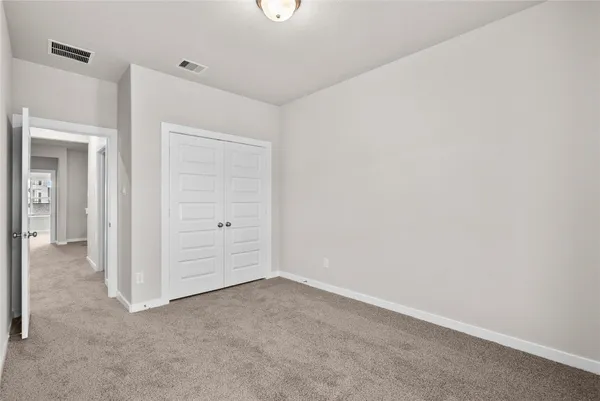 an empty room with closet area