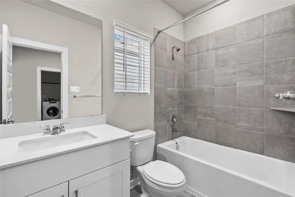 a bathroom with a sink a toilet and bathtub