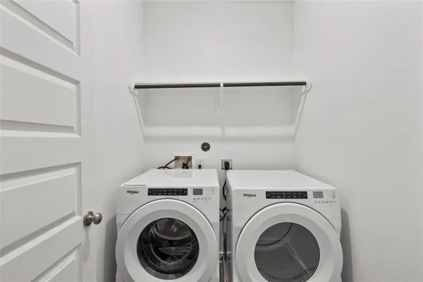 a view of storage and utility room with washer and dryer