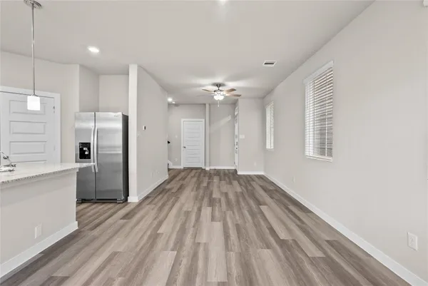 a view of a kitchen with a sink and refrigerator