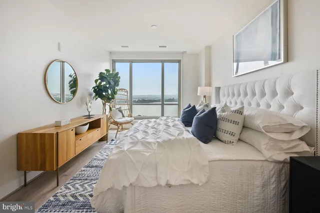 a large bed sitting in a bedroom next to a window