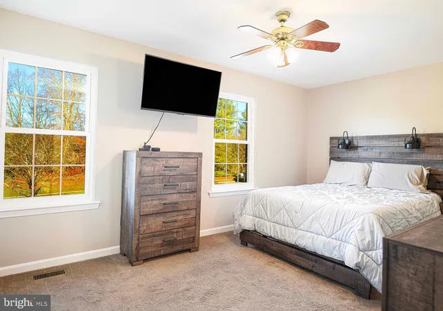 a bathroom with a sink a toilet a mirror and shower curtain