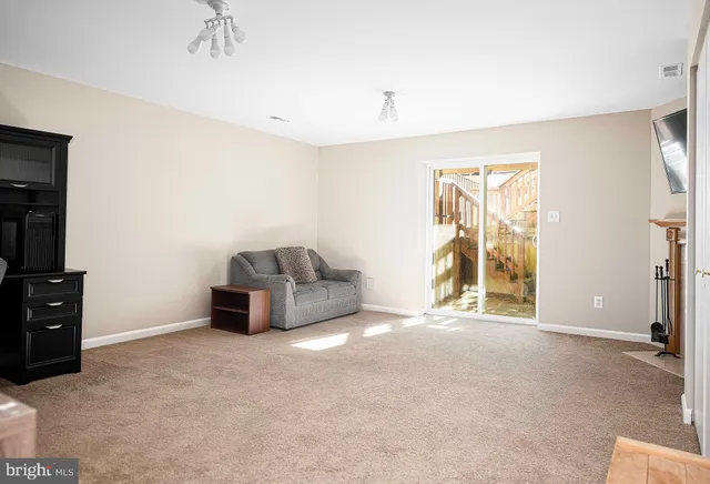 a view of an empty room with a fireplace