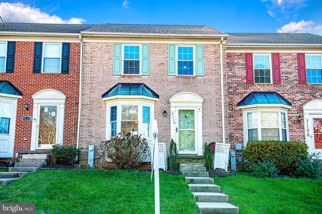 a front view of a house with garden and porch