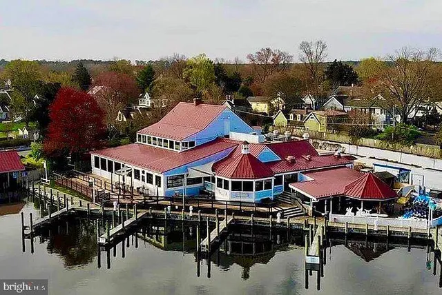 a view of city with dinning table and chairs under an umbrella