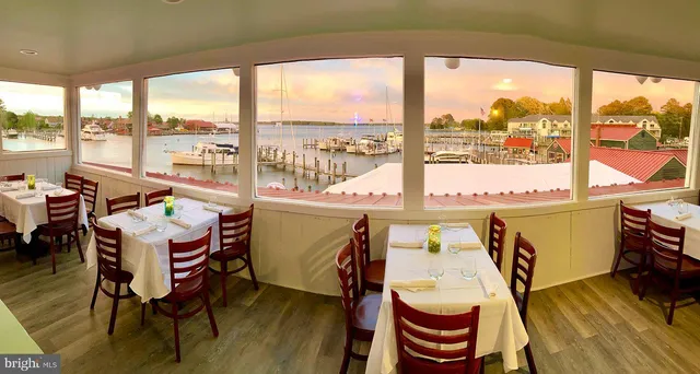 a very nice looking room with a large window and dining table