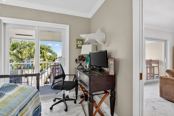 a view of a workspace with furniture and a window