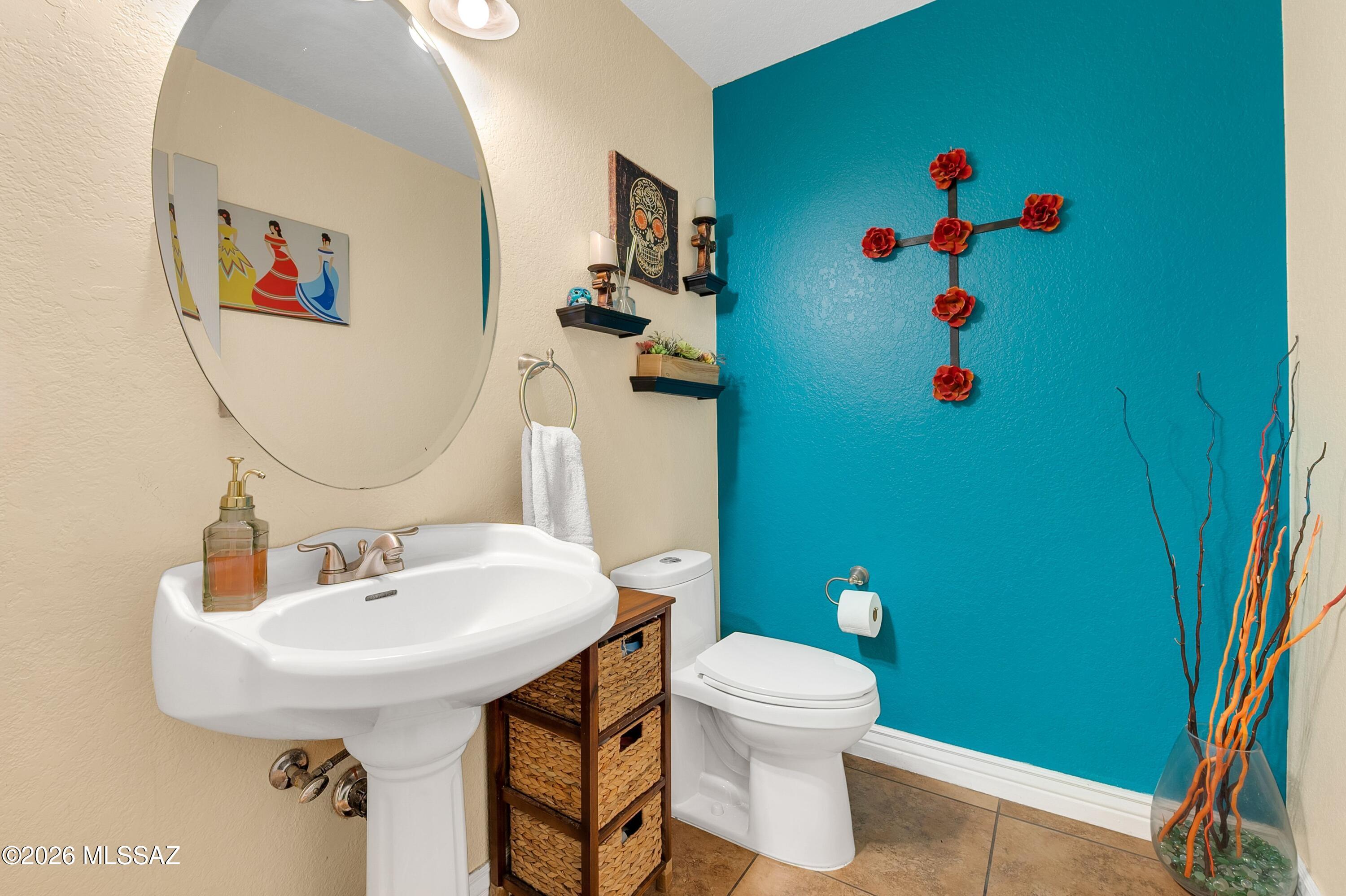 7159 West Maple Ridge Drive Tucson, AZ 85743 - Photo 15 of 42 a bathroom with a toilet sink and mirror