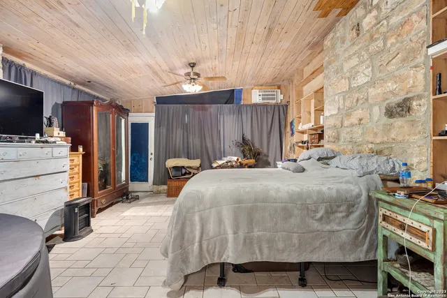 a bed room with a bed and a television