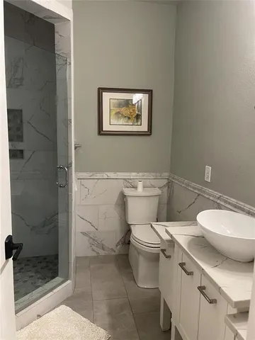 a white toilet sitting next to a bathroom sink