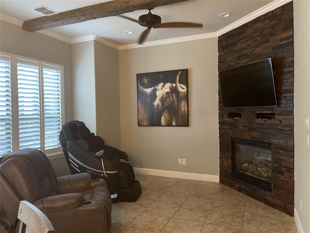 5724 Tupelo Drive Plano, TX 75024 - Photo 7 of 14 a living room with furniture a flat screen tv and a fireplace