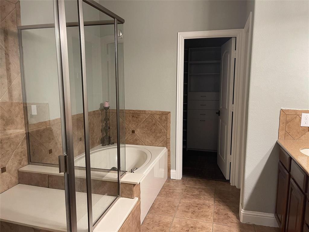 5724 Tupelo Drive Plano, TX 75024 - Photo 9 of 14 a bathroom with a tub and shower