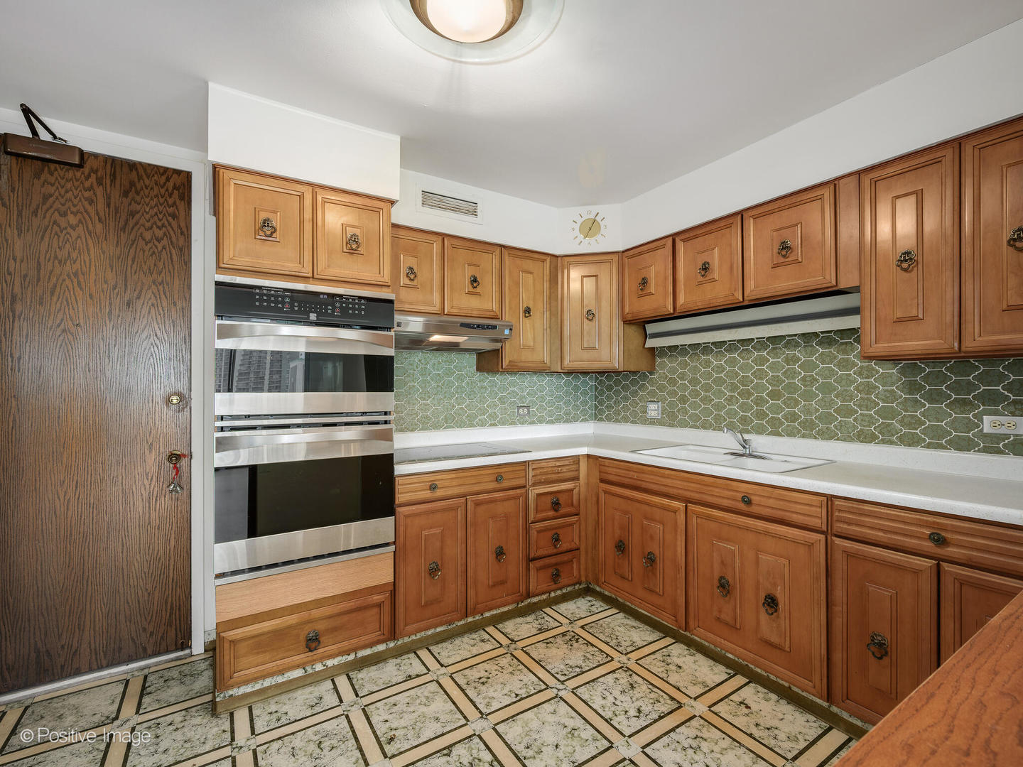 5855 North Sheridan Road, Unit 17D Chicago, IL 60660 - Photo 8 of 18 a kitchen with stainless steel appliances granite countertop a refrigerator and a stove top oven