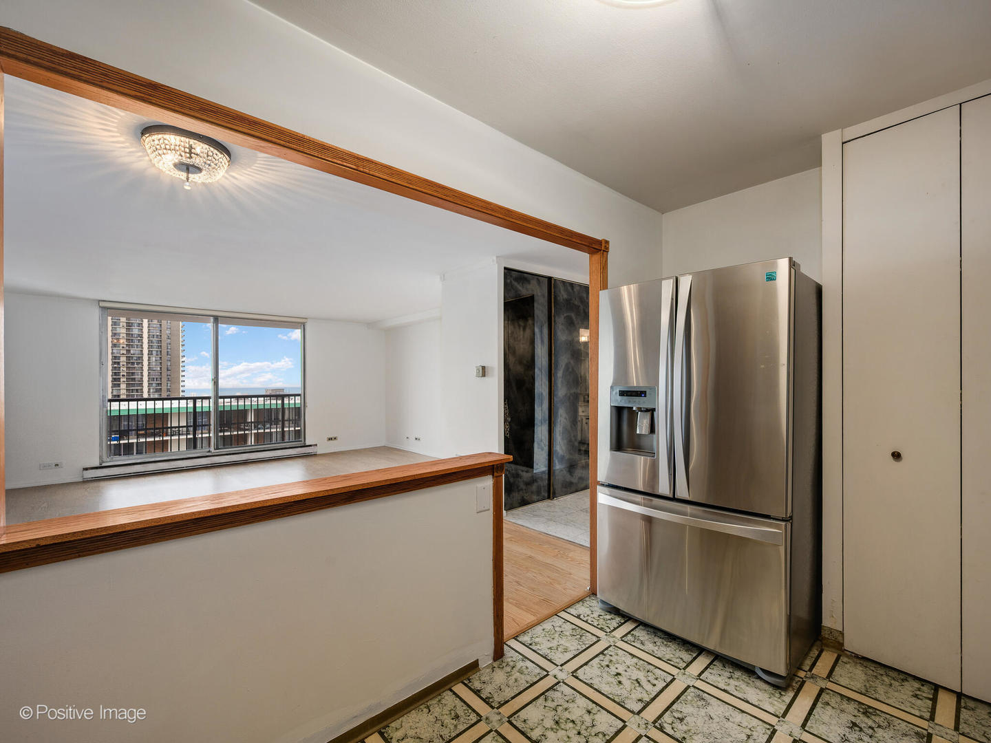 5855 North Sheridan Road, Unit 17D Chicago, IL 60660 - Photo 9 of 18 a kitchen with stainless steel appliances a refrigerator and a sink
