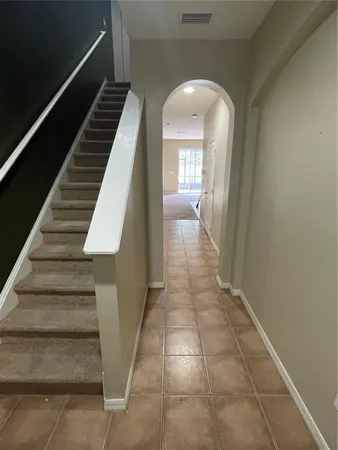 a view of entryway and hall with wooden floor