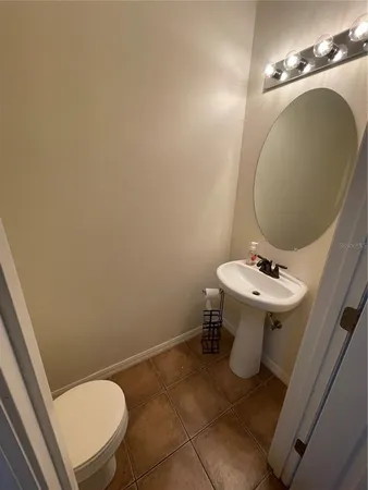 a bathroom with a sink mirror and toilet