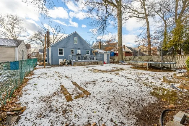 a front view of a house with a yard covered in snow
