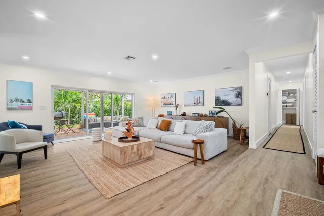 a living room with furniture large window and a fireplace