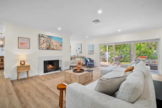 a living room with furniture fireplace and window
