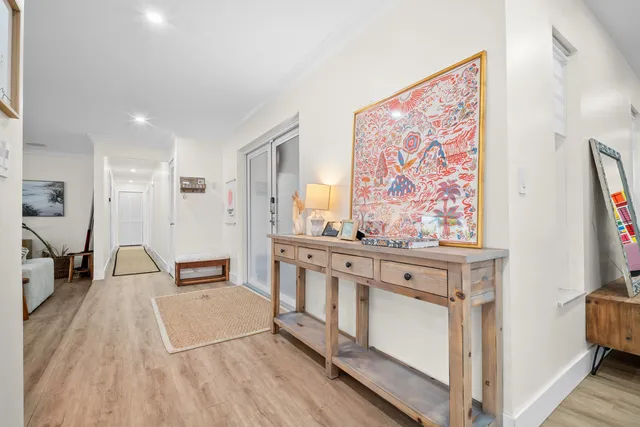 a kitchen with stainless steel appliances kitchen island granite countertop a table chairs sink and cabinets
