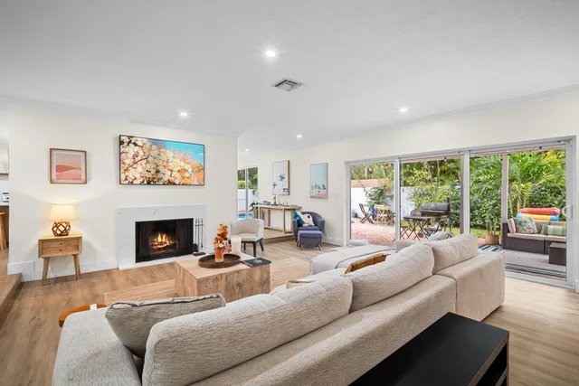 a large white kitchen with lots of counter space wooden floor and appliances