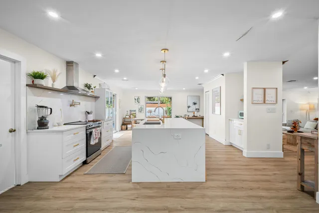 a kitchen with stainless steel appliances a sink and a stove top oven