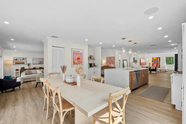 a bedroom with a bed a table and painting