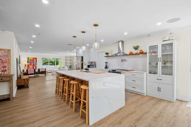 a spacious bedroom with a large bed and a flat screen tv