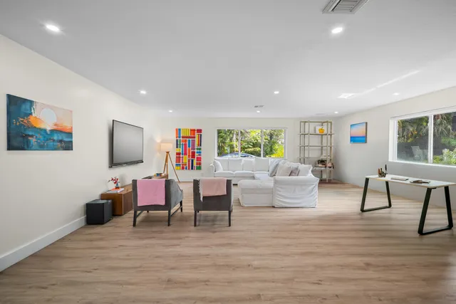a bedroom with furniture and flat screen tv