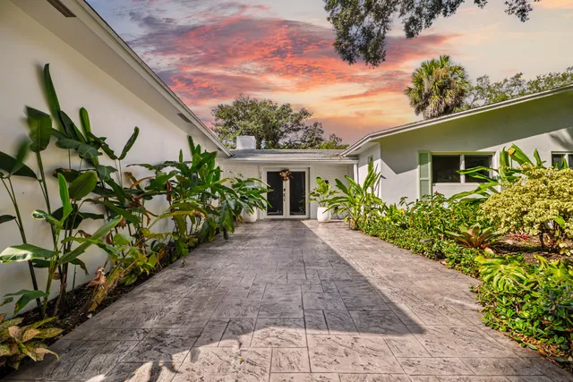 an aerial view of a house with a yard and garden