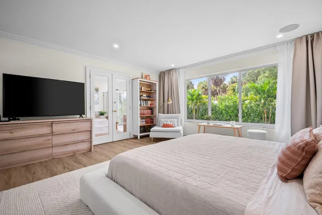 a view of a white house with a swimming pool and sitting area