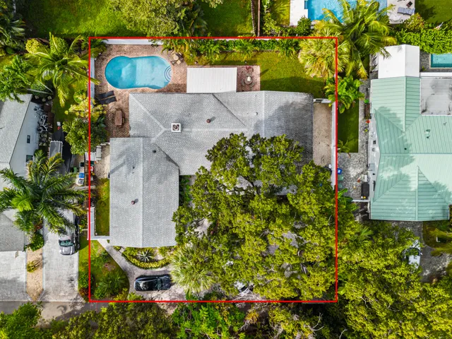 an aerial view of residential house with outdoor space and swimming pool