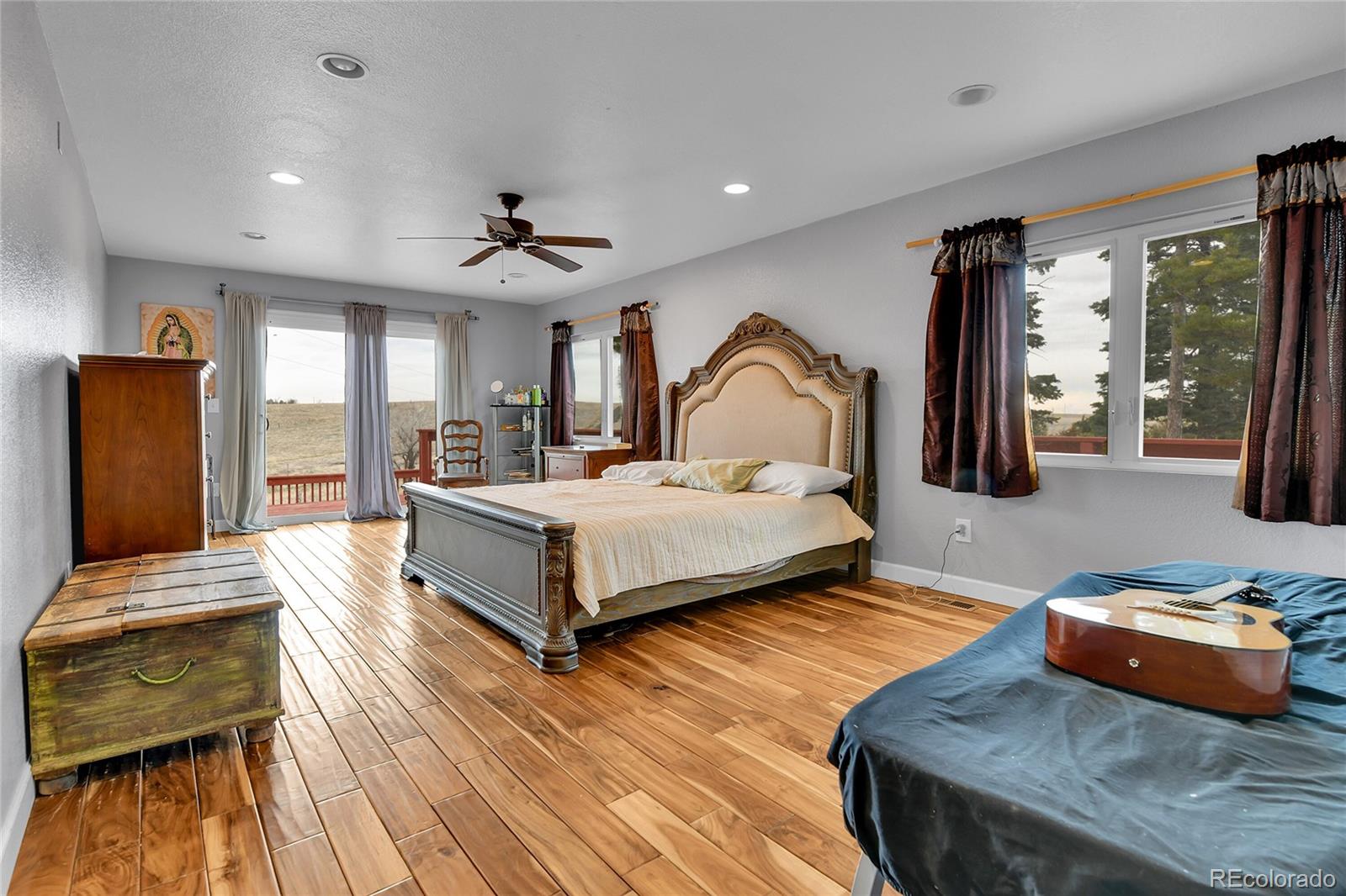 1632 Kiowa-Bennett Road Bennett, CO 80102 - Photo 13 of 42 a bedroom with a bed a couch and dresser