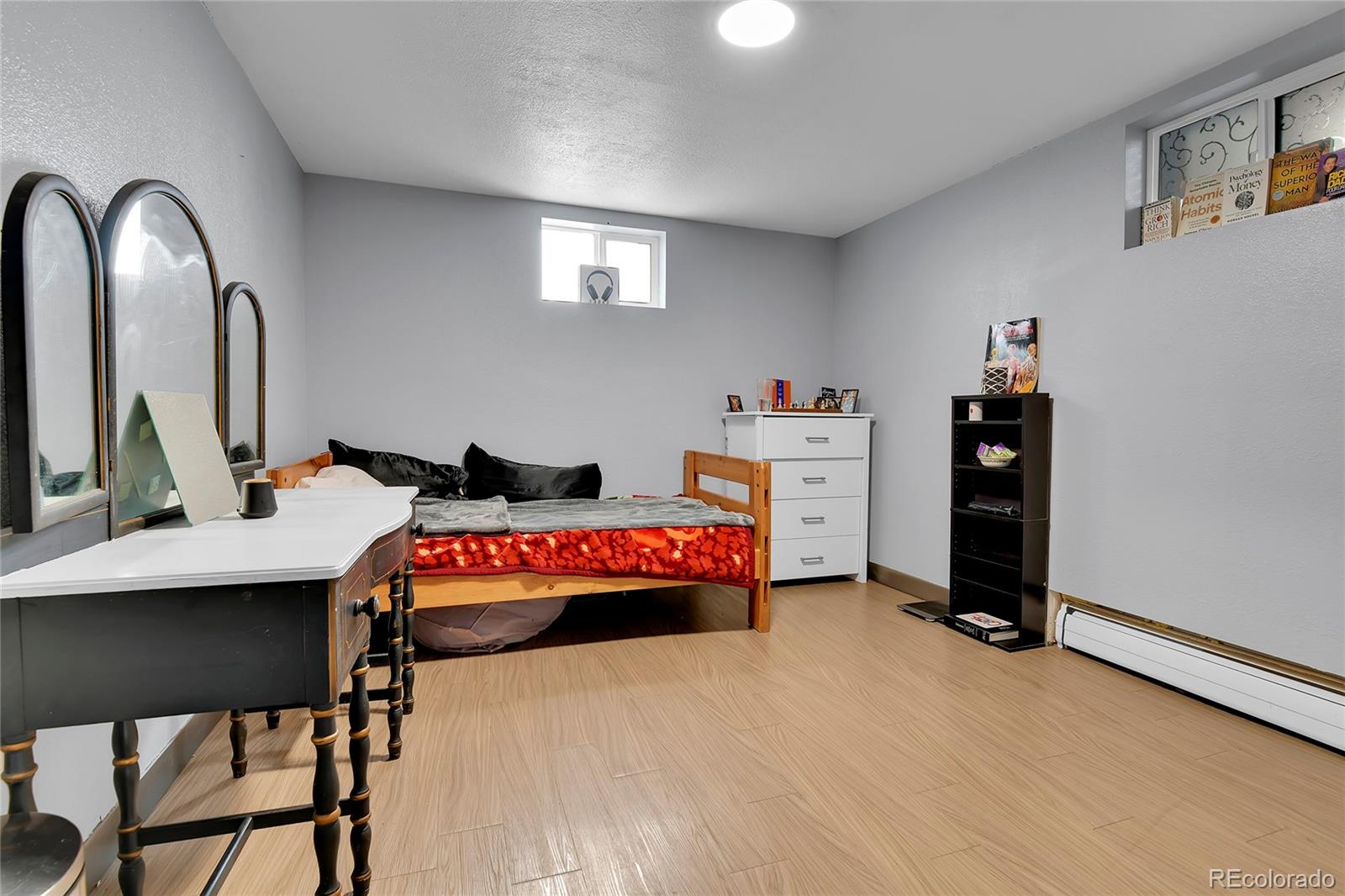 1632 Kiowa-Bennett Road Bennett, CO 80102 - Photo 20 of 42 a bedroom with a bed and a chandelier