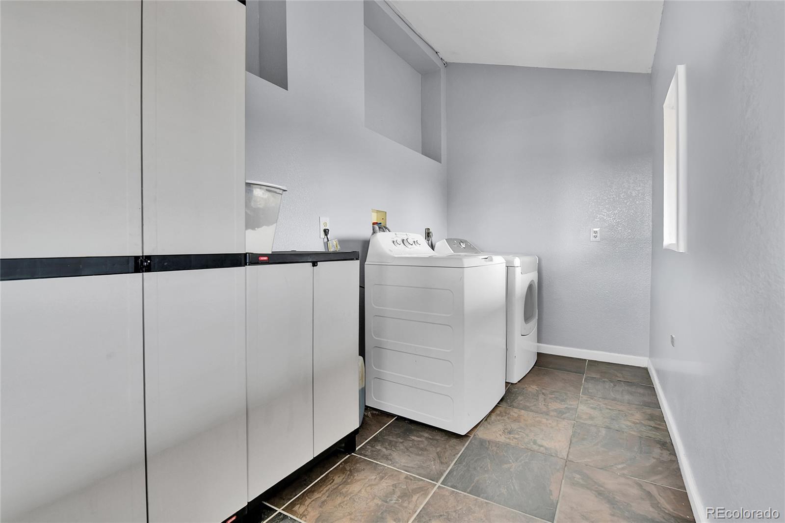 1632 Kiowa-Bennett Road Bennett, CO 80102 - Photo 27 of 42 a utility room with cabinets
