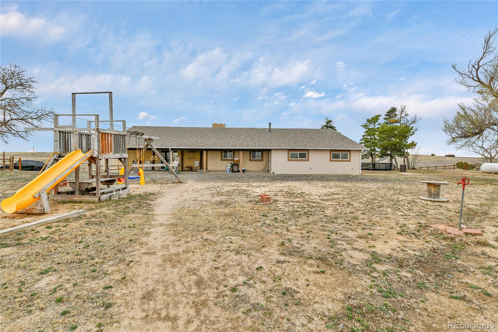 1632 Kiowa-Bennett Road Bennett, CO 80102 - Photo 28 of 42 a view of a house with a patio