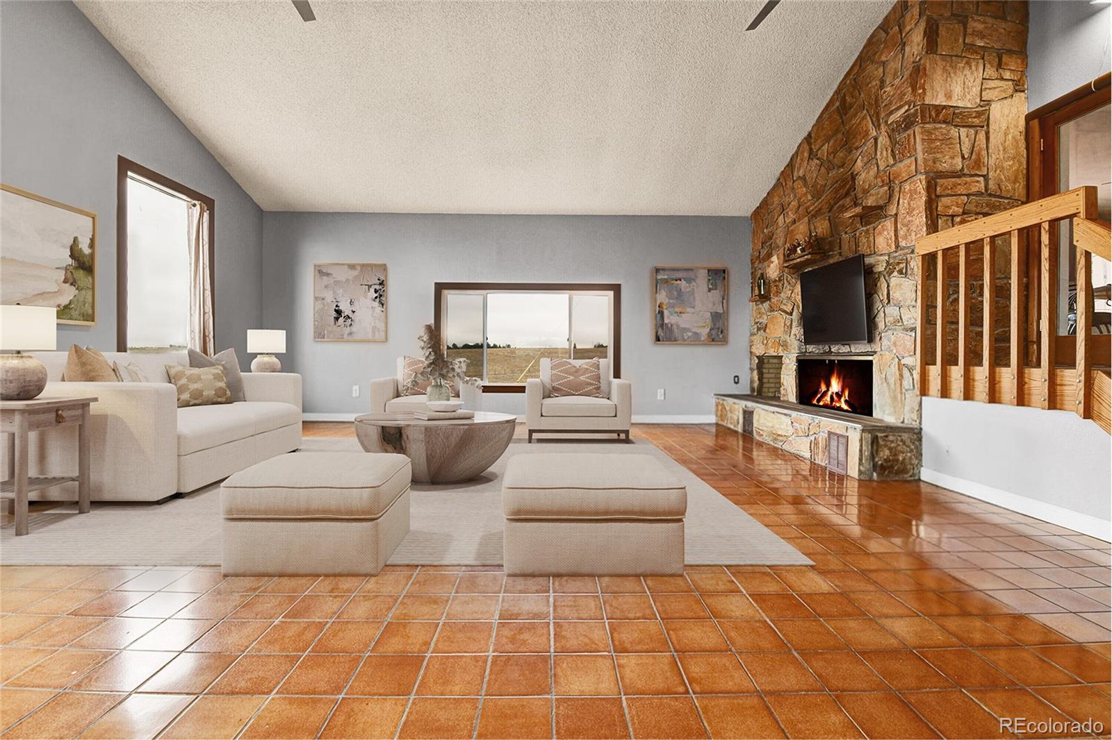 1632 Kiowa-Bennett Road Bennett, CO 80102 - Photo 3 of 42 a living room with couches and a fireplace with kitchen view